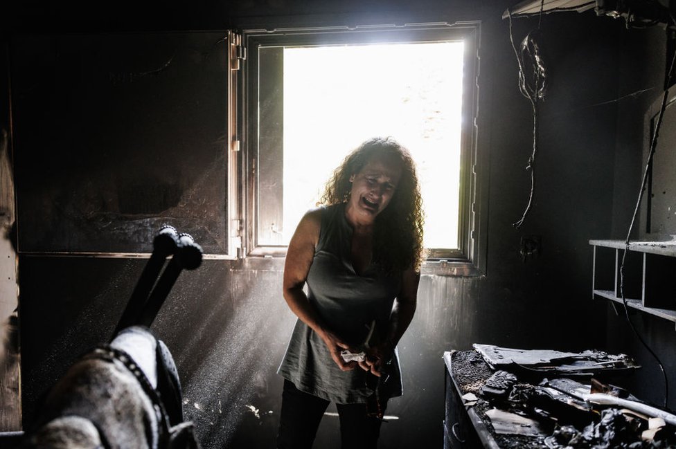 Kibbutz Nir Oz resident Hadas Kalderon, whose children were taken hostage, and her mother and niece killed, breaks down in tears while looking through the burnt out home of her late mother Rina Sutzkever on October 30, 2023 in Kibbutz Nir Oz, Israel.