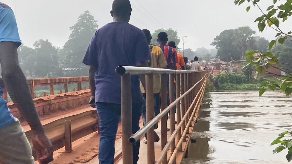 People crossing the bridge in Bambari, CAR