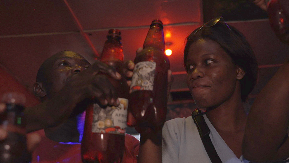 People drinking Russian beer at the Cave bar in Bangui, CAR