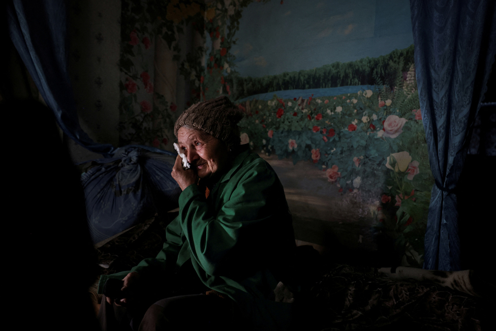Lyubov Vasilivna, 71, reacts when listing reasons to remain in her home and not evacuate from the village of Semenivka, near the frontline town of Avdiivka, in the eastern Donetsk region, Ukraine, March 28, 2023.