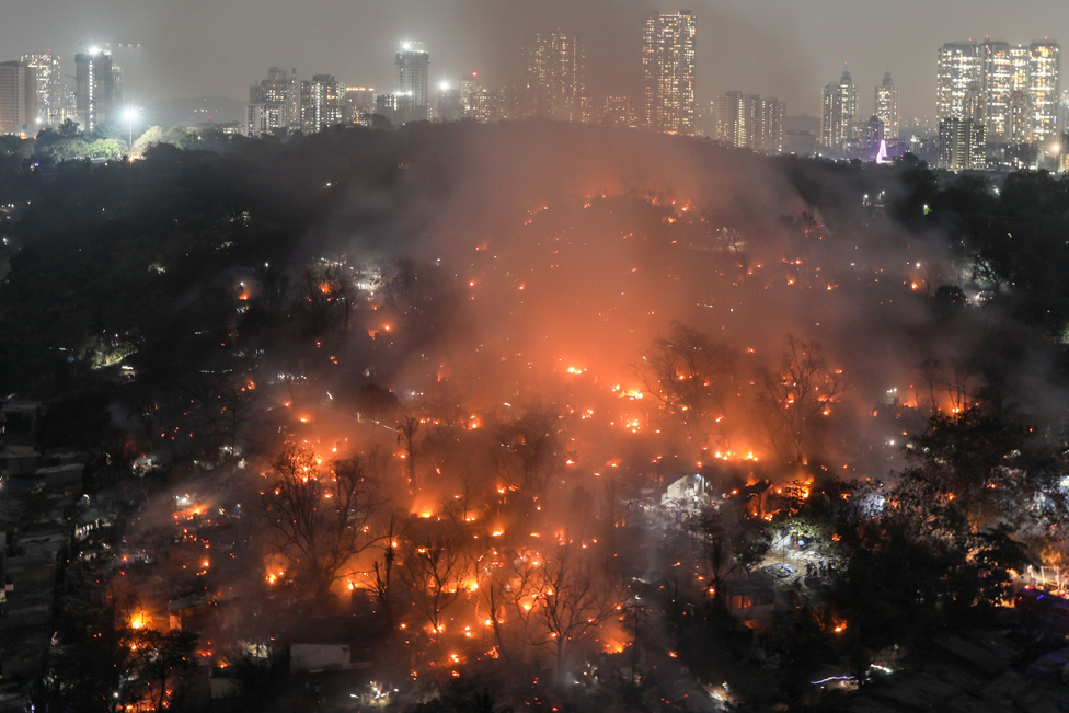 Smoke billows after a level-three fire broke out inside the Appa Pada slums in Mumbai, India, 13 March 2023.