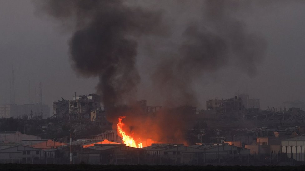 Fire burns inside central Gaza strip following an airstrike, amid the ongoing conflict between Israel and the Palestinian Islamist group Hamas, as seen from southern Israel, December 11, 2023.