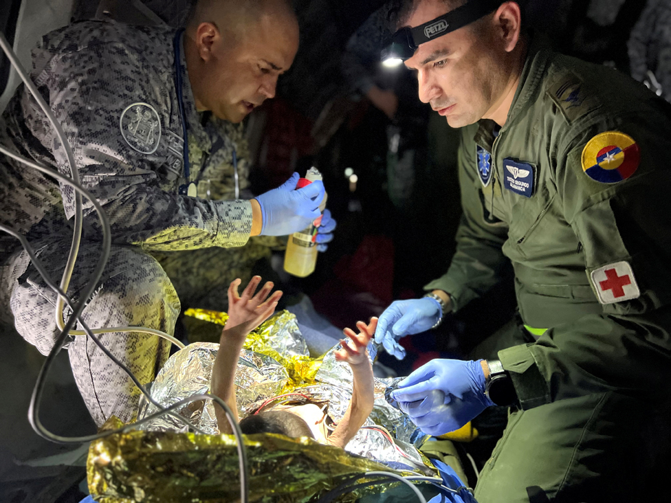Members of the Colombian Air Force give medical attention inside a plane to the surviving children of a Cessna 206 plane crash in the thick jungle, while they are transferred to Bogota by air in San Jose del Guaviare, Colombia, June 9, 2023.
