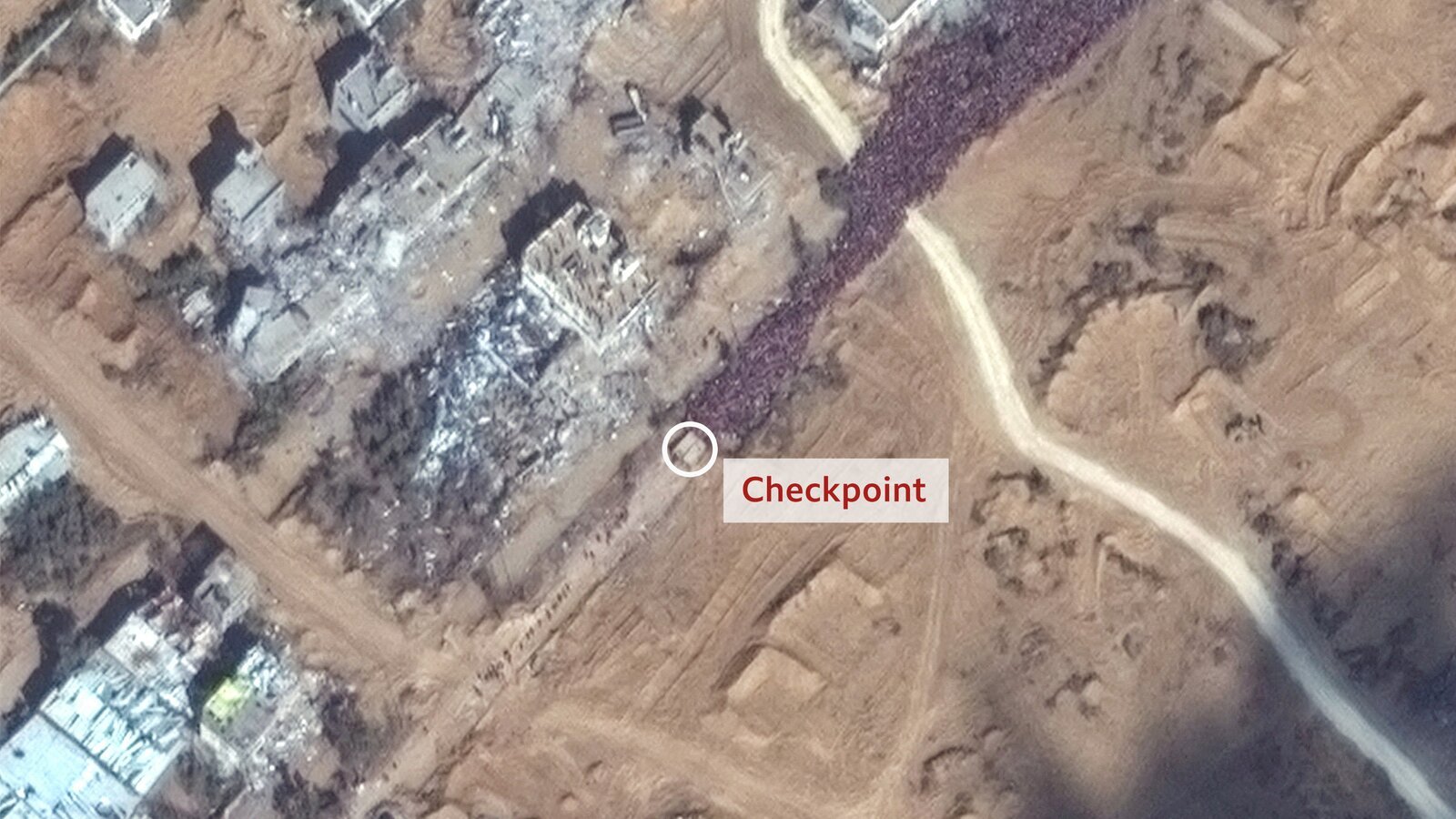 The Israeli checkpoint on the Salah al-Din road that Jehad and his family passed through. There is a huge crowd of people waiting to go through it.