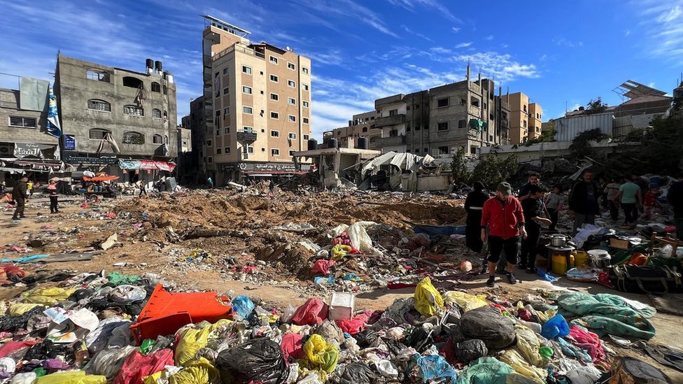 Palestinians inspect damages following an Israeli raid at Kamal Adwan hospital in the northern Gaza Strip
