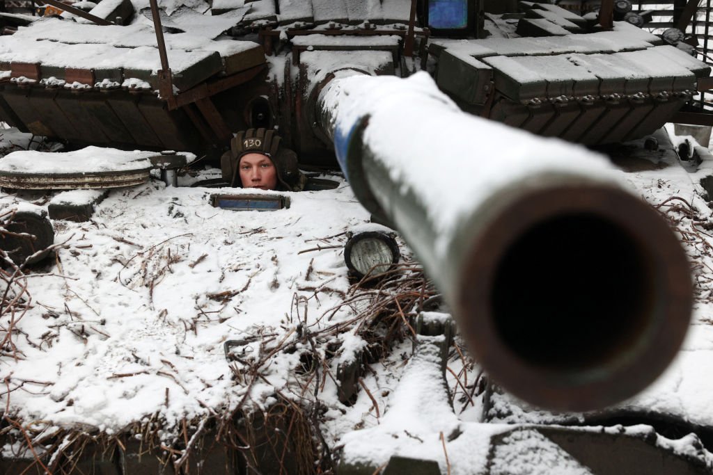 A Ukrainian soldier looks out from a tank as he holds his position near to the town of Bakhmut, Donetsk region, on December 13, 2023