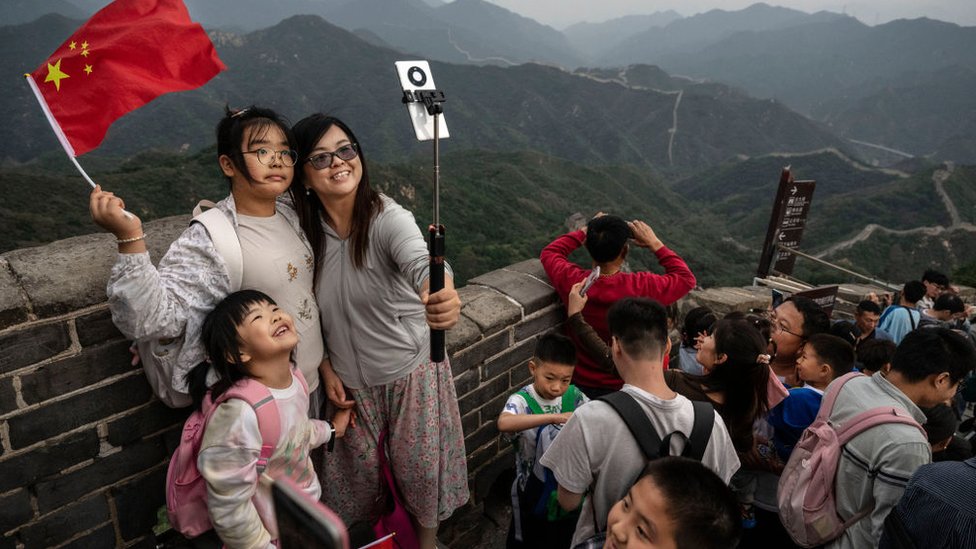 Kina: Kako Komunistička partija učestvuje u provodadžisanju 4 A family takes photos as they and others visit a section of the Great Wall during the National Golden Week holiday on October 2, 2023 in Beijing,