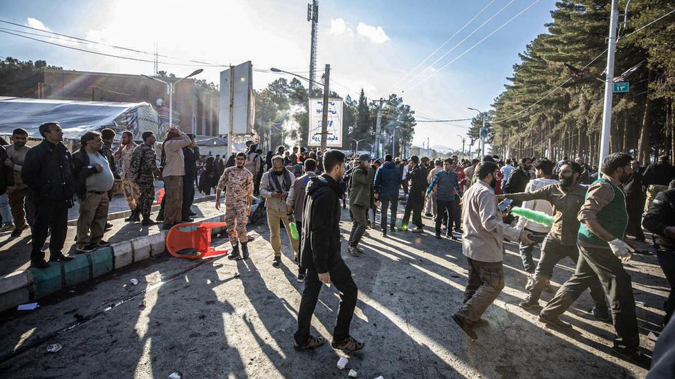 Bystanders at the scene of an explosion near Qasem Soleimani's tomb in Kerman, Iran (3 January 2023)