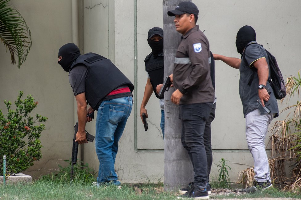 Police officers carry out an operation at the headquarters of TC television station where armed, hooded men entered and subdued staff during a live broadcast, in Guayaquil, Ecuador, 09 January 2024.