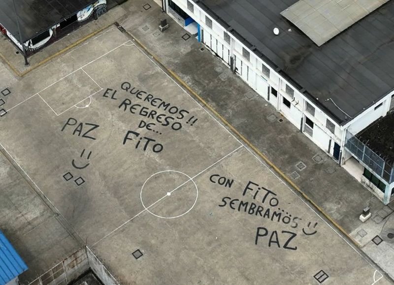 An aerial view of the courtyard of a prison with slogans painted in support of "Fito"