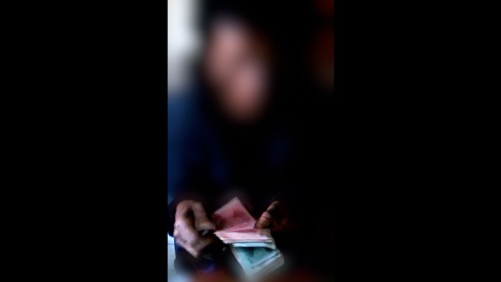 Blurred image of a North Korean counts the money after receiving the delivery from the brokers