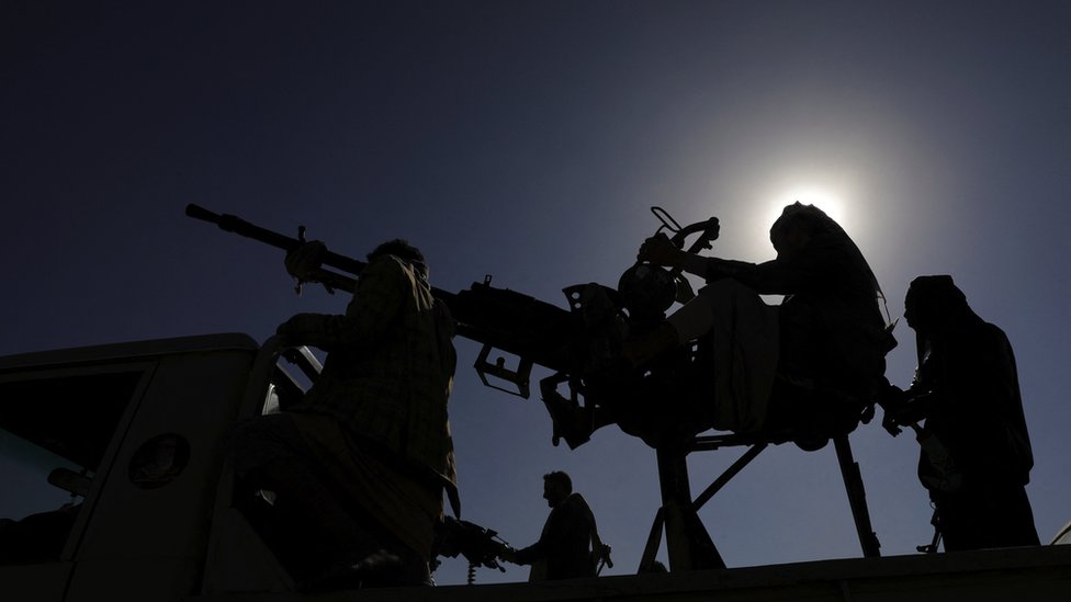 Armed Houthi followers man machine guns mounted on a pick-up truck during a protest near Sanaa, Yemen on 25 January 2024