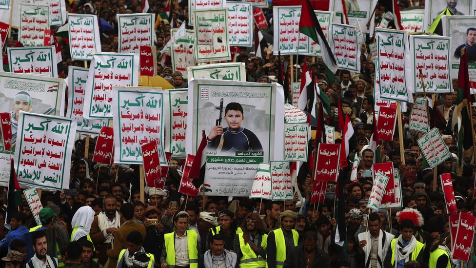 Houthi supporters hold banners depicting Houthi fighters who were killed in recent US-led bombing of Houthi positions, and placards reading in Arabic: 'Allah is the greatest of all, death to America, death to Israel, a curse on the Jews, victory to Islam' during a protest against the 'terrorist' designation of the Houthis by the US government, in Sanaa, Yemen, on 19 January 2024