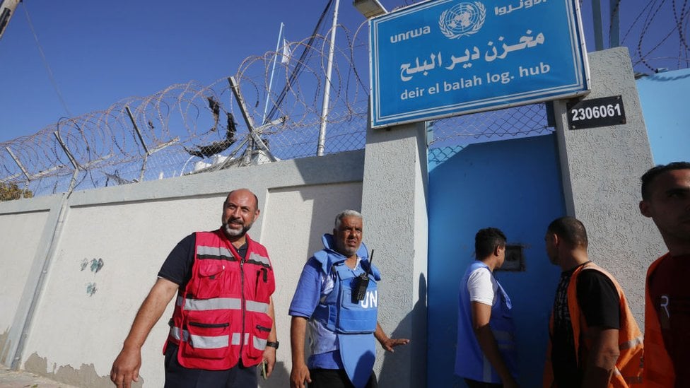 Trucks carrying humanitarian aid for Palestinians that entered Gaza through Rafah border crossing on the Egyptian border arrive at the UNRWA warehouse, in Deir al Balah,
