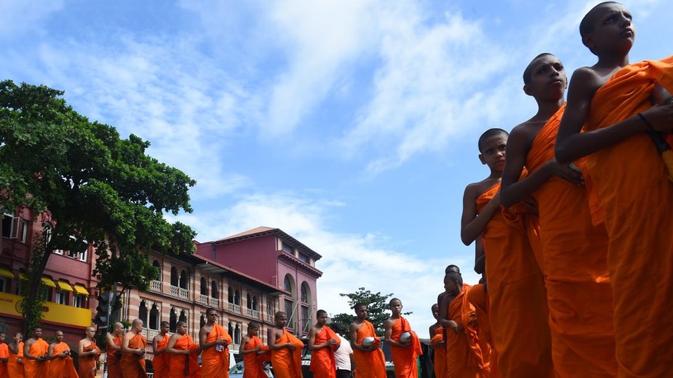 Sri Lankan Buddhist monks loyal to former president Mahinda Rajapaksa beg for money in Colombo on September 15, 2017, to pay the fine of his top aide who was jailed for three years for misappropriating 600 million rupees ($4 million) in public funds to boost his failed re-election campaign in January 2015.