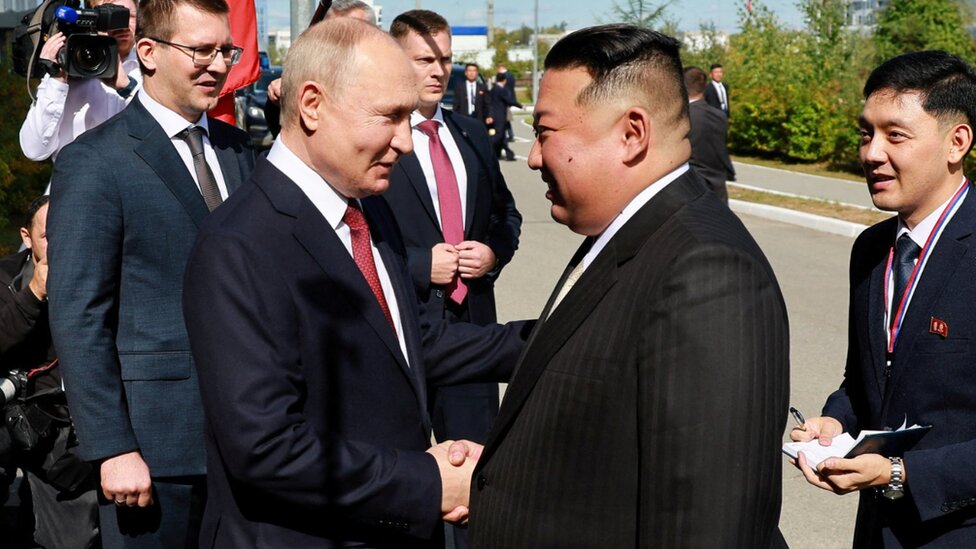 Vladimir Putin shakes hands with Kim Jong Un as the two leaders are reunited in a meeting at Vostochny Cosmodrome in Russia's far east, 13 September 2023