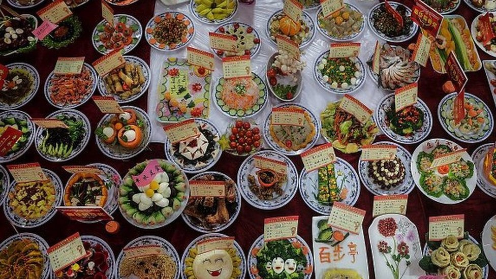 Homemade dishes sit on a table during a Lunar New Year gathering on February 9, 2018 in Wuhan, Hubei province