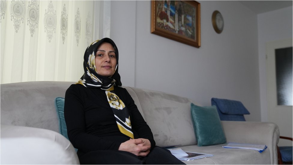 Nurgül Göksu sitting in her living room