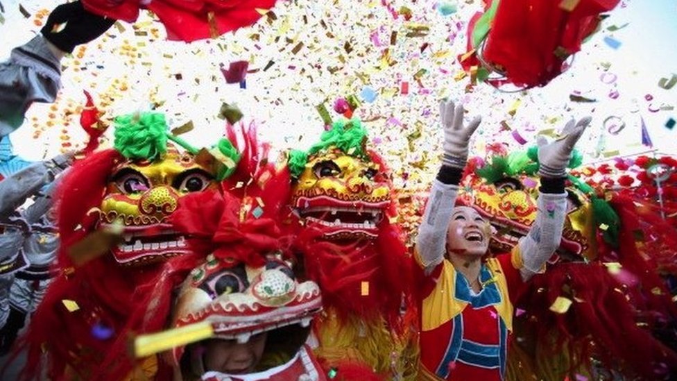 Chinese folk artists perform the lion dance at a temple fair to celebrate the Lunar New Year
