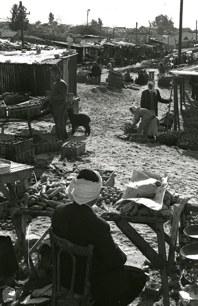 Palestinian refugees shop in the old market in Rafah in 1975