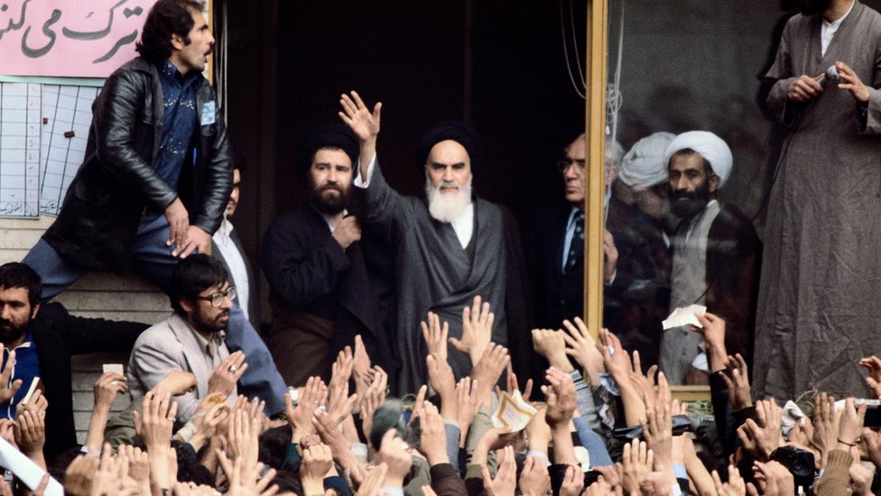 Ayatollah Khomeini waves to a crown on his return to Iran in 1979