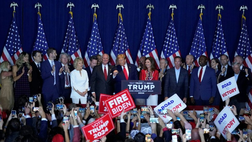 Nearly two dozen allies flanked Mr Trump during his victory speech