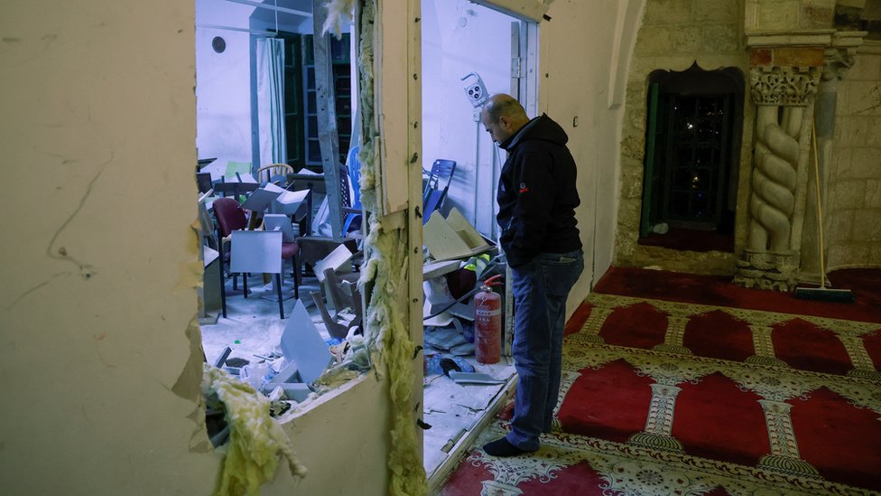 A man looks at damage inside the al-Aqsa mosque, following clashes between Israeli police and Palestinian worshippers, in East Jerusalem, 5 April 2023