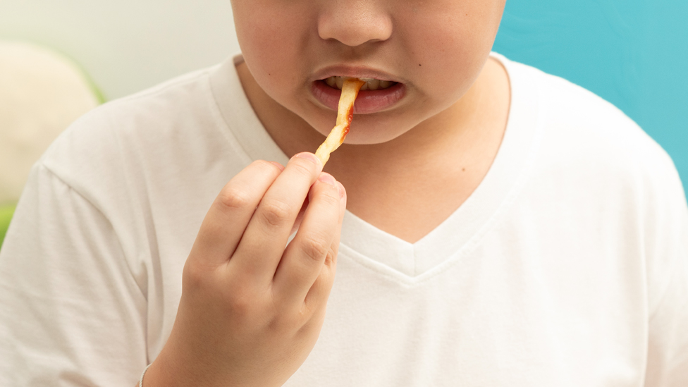 A child eats a fry
