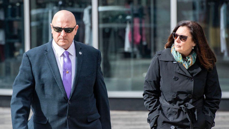 Jack Teixeira's stepfather Thomas Dufault and mother Dawn Dufault walk outside a court house