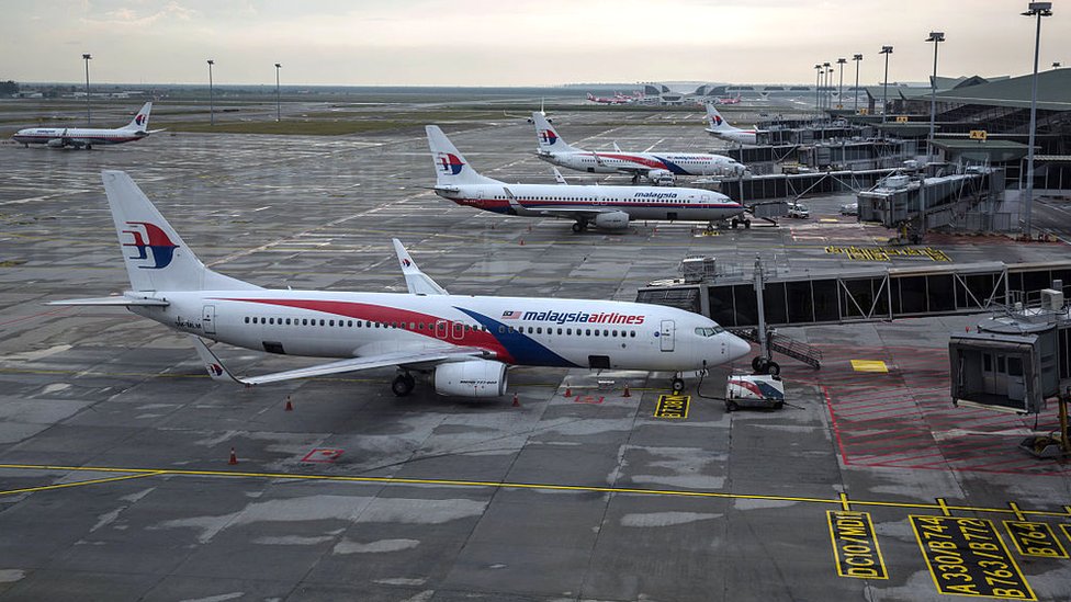 Malaysian Airlines aircraft are seen through a window as they stand on the tarmac at Kuala Lumpur International Airport (KLIA) in Sepang, Selangor, Malaysia, on Tuesday, Jan. 17, 2017.