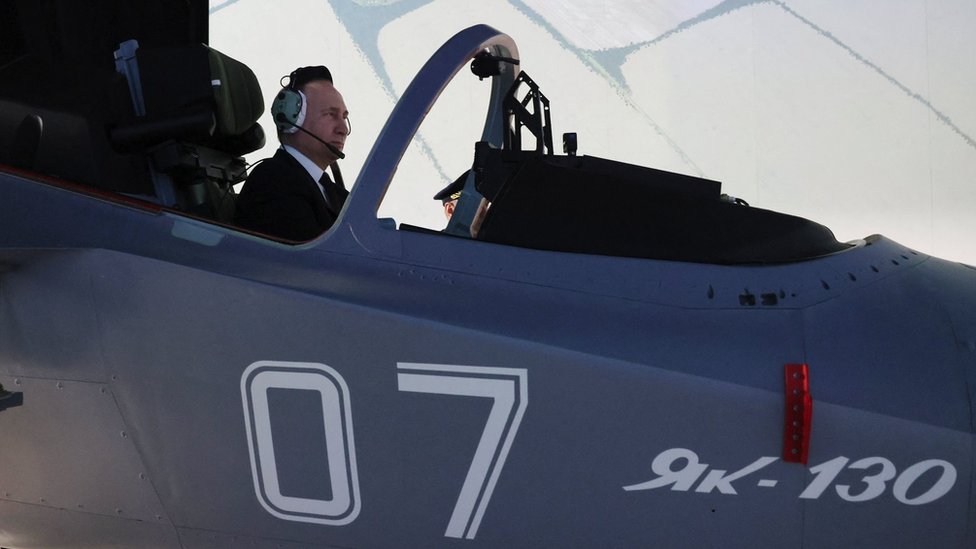 Vladimir Putin sitting in an aircraft