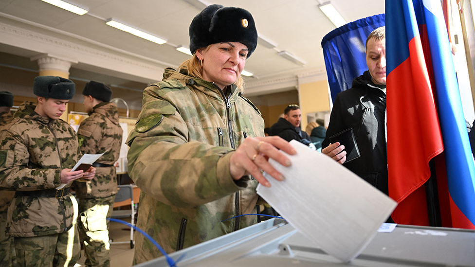 A service member casts her ballot in Russia's presidential election in Moscow on March 15, 2024