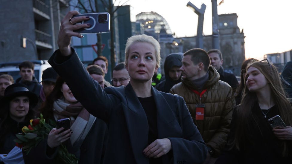 Yulia Navalnaya, widow of late Russian opposition figure Alexei Navalny, does a selfie as the Reichstag stands behind after she voted in Russian elections on March 17, 2024 in Berlin, Germany