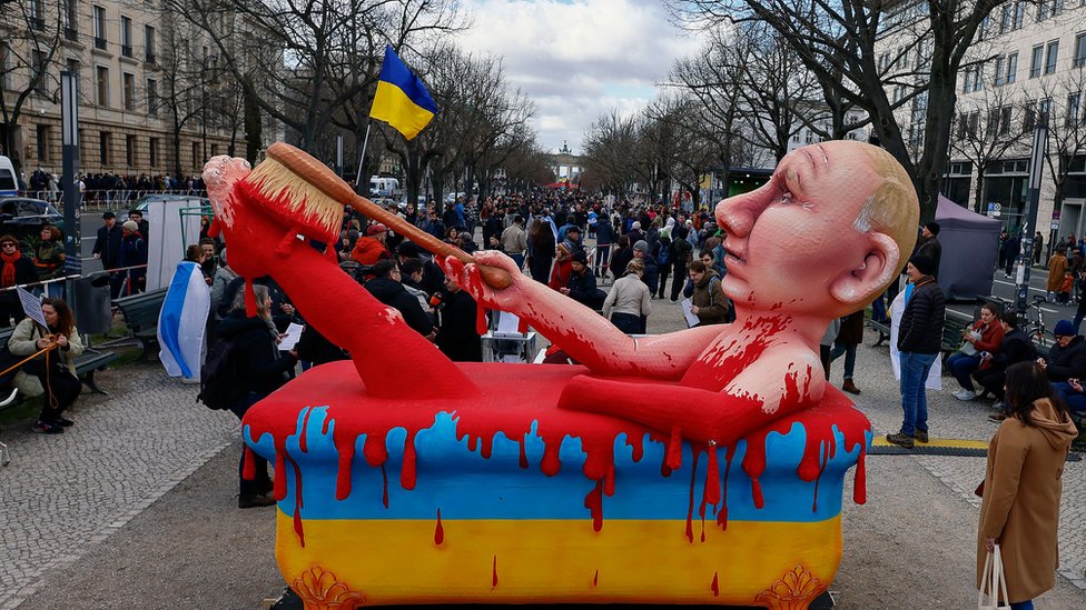 An inflatable model of Vladimir Putin in a pool of blood.