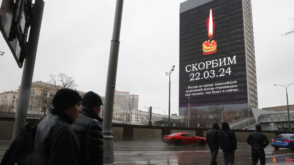 Napad u Moskvi: Dok Rusija žali za žrtvama čeka se reakcija Vladimira Putina 1 Screens all around Moscow are showing images of a burning candle along with the Russian word "Skorbim" ("We mourn").