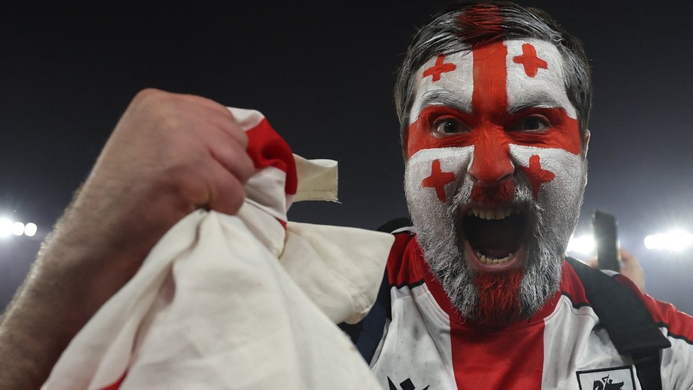 Georgia fan celebrates his team reaching Euro 2024