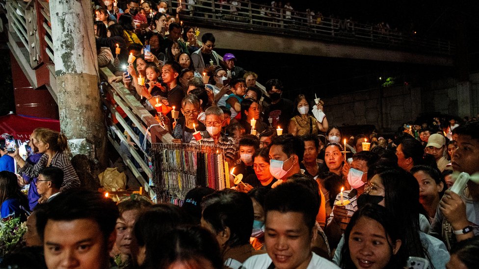 Crowds gather on stairs for a traditional procession in the Philippines