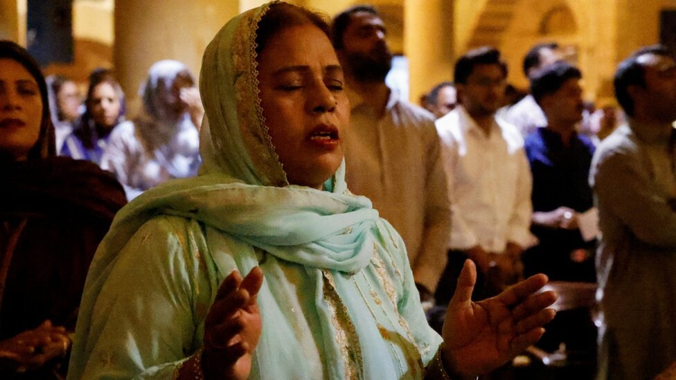A woman attends the Easter Sunday service at the Holy Trinity Cathedral Church of Pakistan, in Karachi