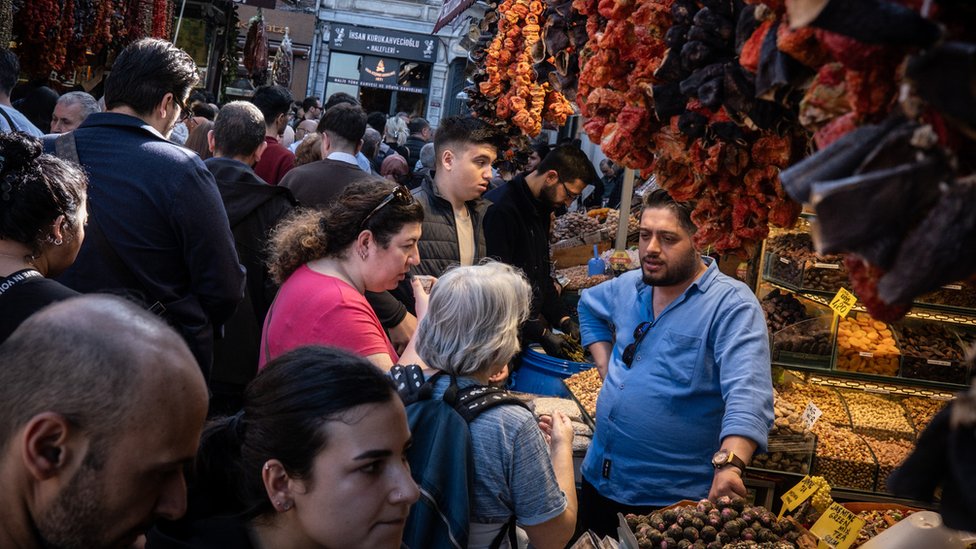 People shop in a busy market street in the Eminonu district ahead of the local elections on March 29, 2024 in Istanbul, Turkey.