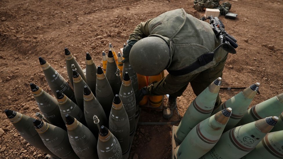 An Israeli soldier checks artillery shells at an area along the border with Gaza, in southern Israel (9 October 2023)
