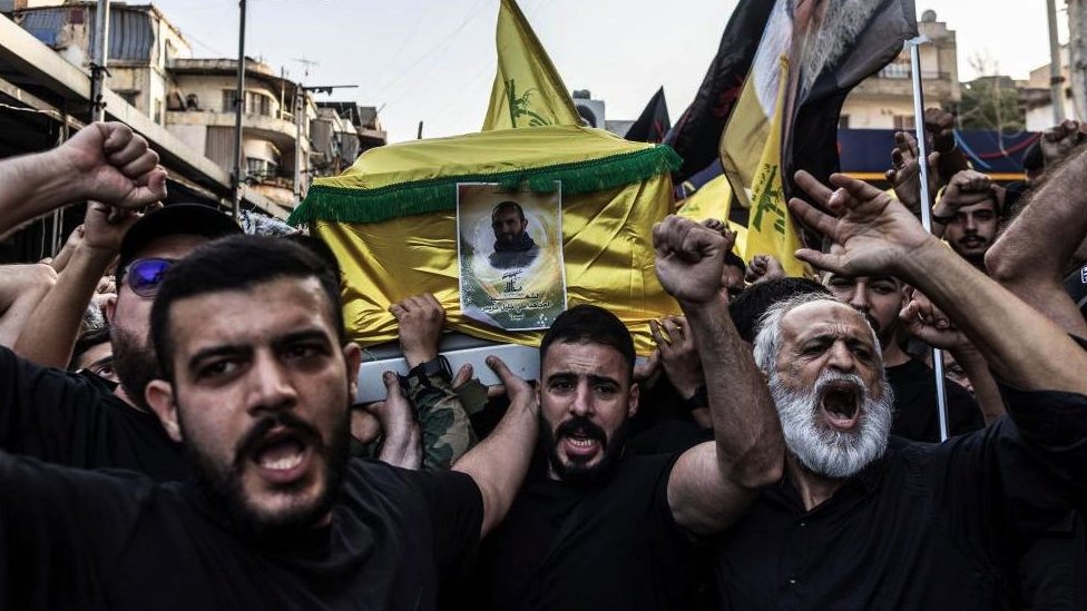 Hezbollah supporters shout anti-Israel slogans at a Beirut funeral