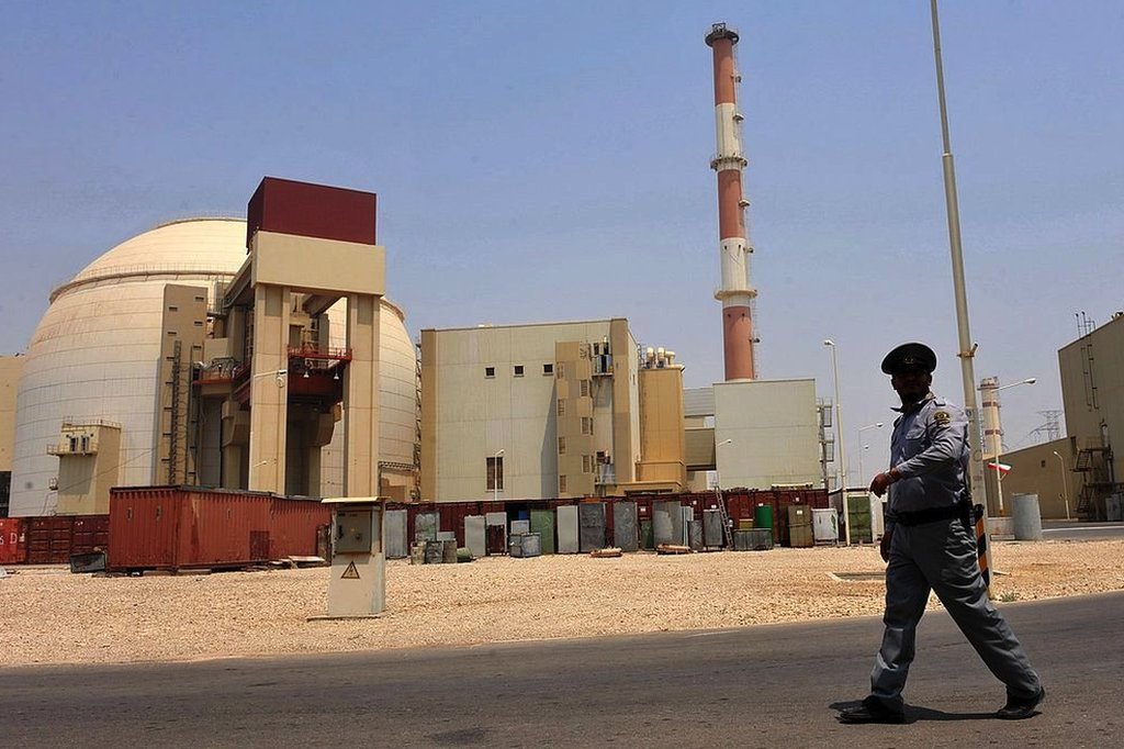 A man in uniform stands guard at an Iranian nuclear facility