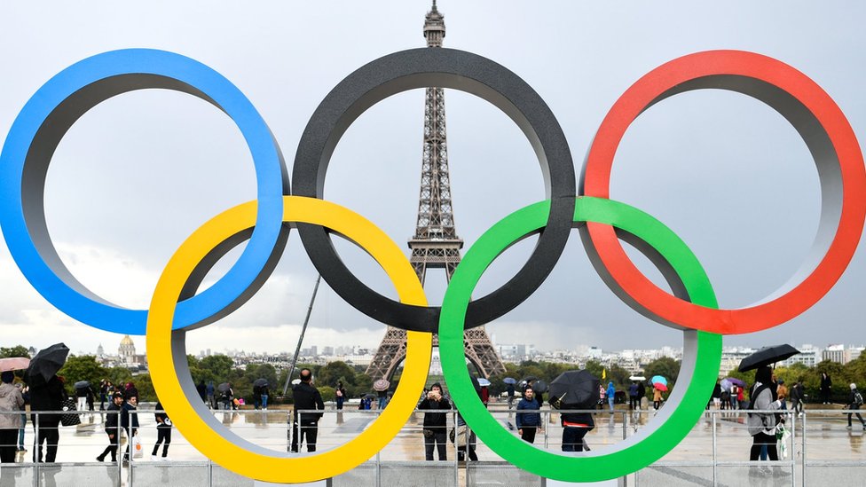 Olympic rings in Paris, with Eiffel Tower in background