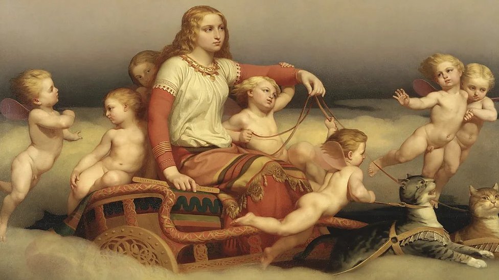 Od drevnog Egipta do Tejlor Svift: Istorijski koreni ljubiteljki mačaka 1 Žena okružena anđelima