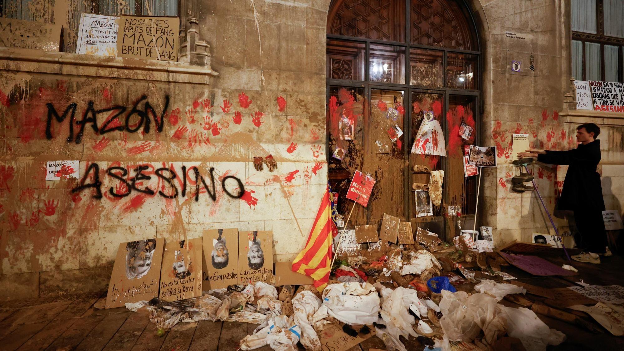 „Mi smo umrljani blatom, a vi krvlju”: Hiljade na protestima u Valensiji 3 A person stands in front of Valencia's Regional Government Palace, which is stained with mud and paint, during a protest against Valencia's regional leader Carlos Mazon and the management of the emergency response to the deadly floods in eastern Spain, in Valencia, Spain,