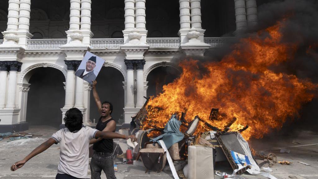 Nepal: Vojska uspostavila mir, prva žena premijer u istoriji zemlje 5 Demonstranti bacaju u vatru fotografiju premijera Šarma Olija koji je podneo ostavku, ispred zauzete zgrade skupštine