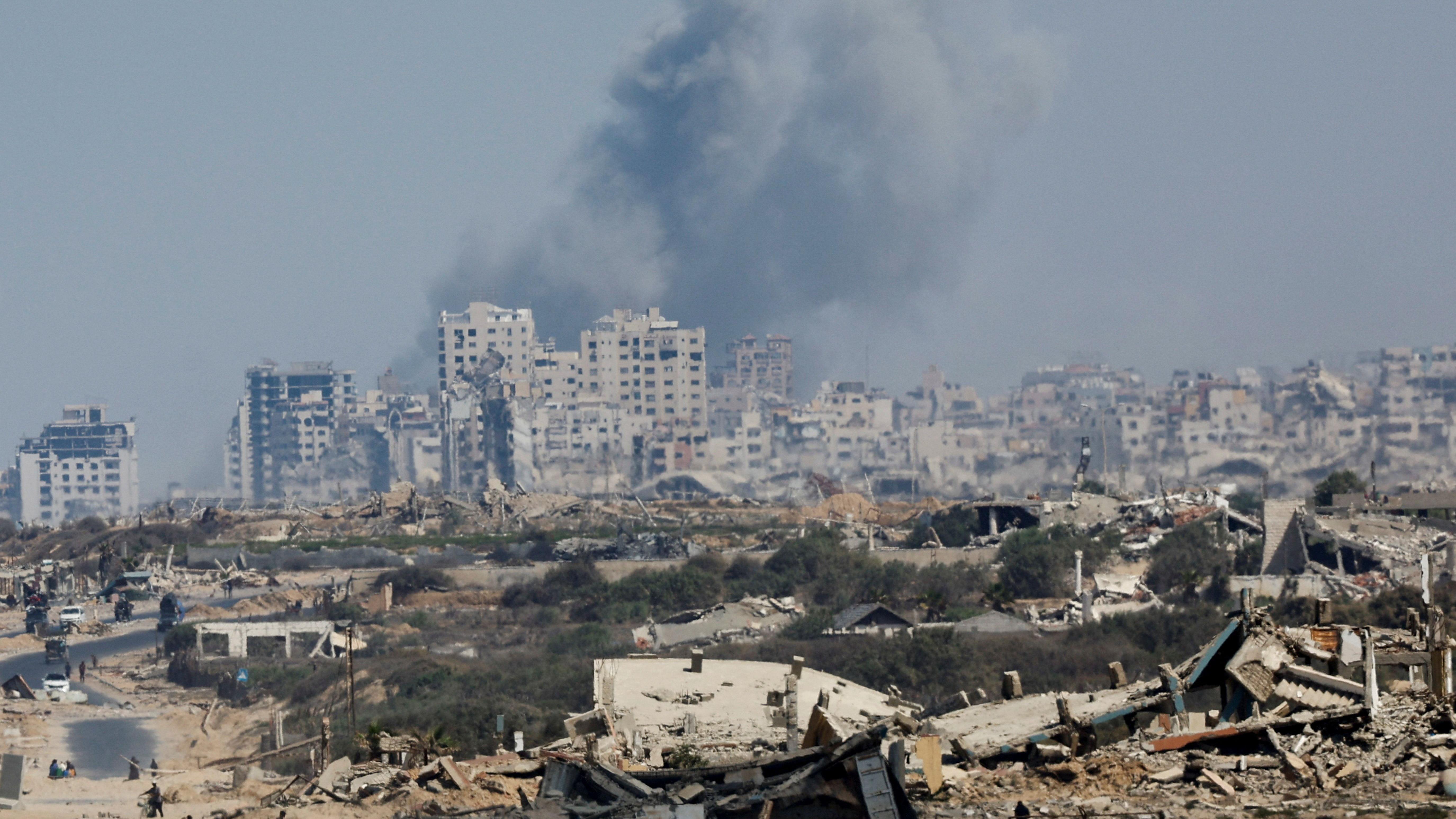 Smoke rises during an Israeli military operation in Gaza City on 29 September. Buildings have been destroyed and the ground was littered with debris