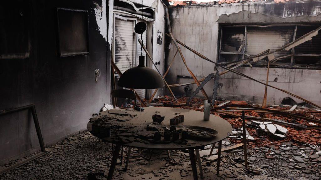 Šporet, srušeni zidovi i komadi ruševina u crnoj, izgoreloj sobi kuće u kibucu Beri na jugu Izraela