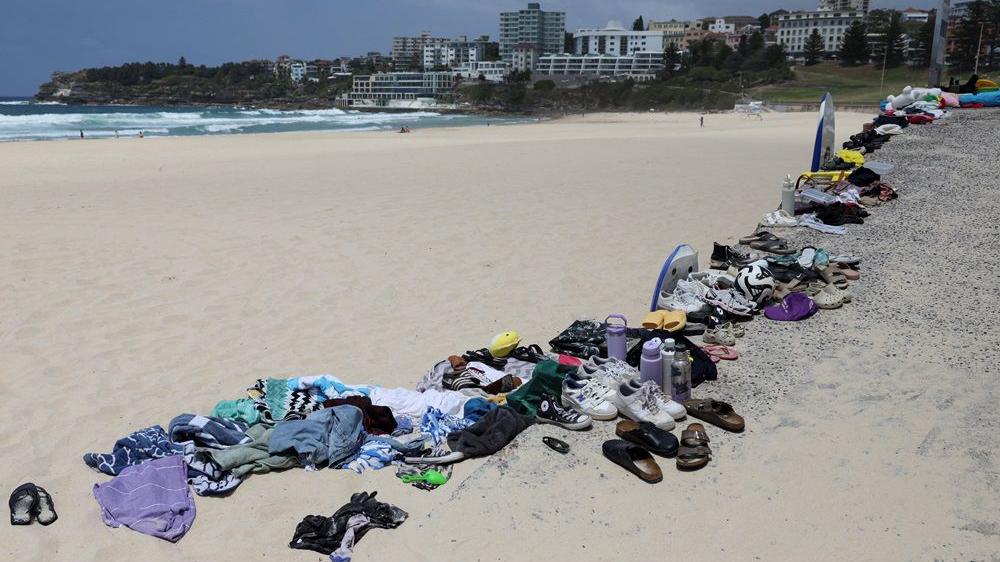 Pucnji na jevreje u Sidneju: 15 ubijenih, desetine ranjenih - šta se zna o napadačima 1 pucnjava u australiji, stvari ubijenih i ranjenih poređane na plaži, patike i odeća poređani na plaži