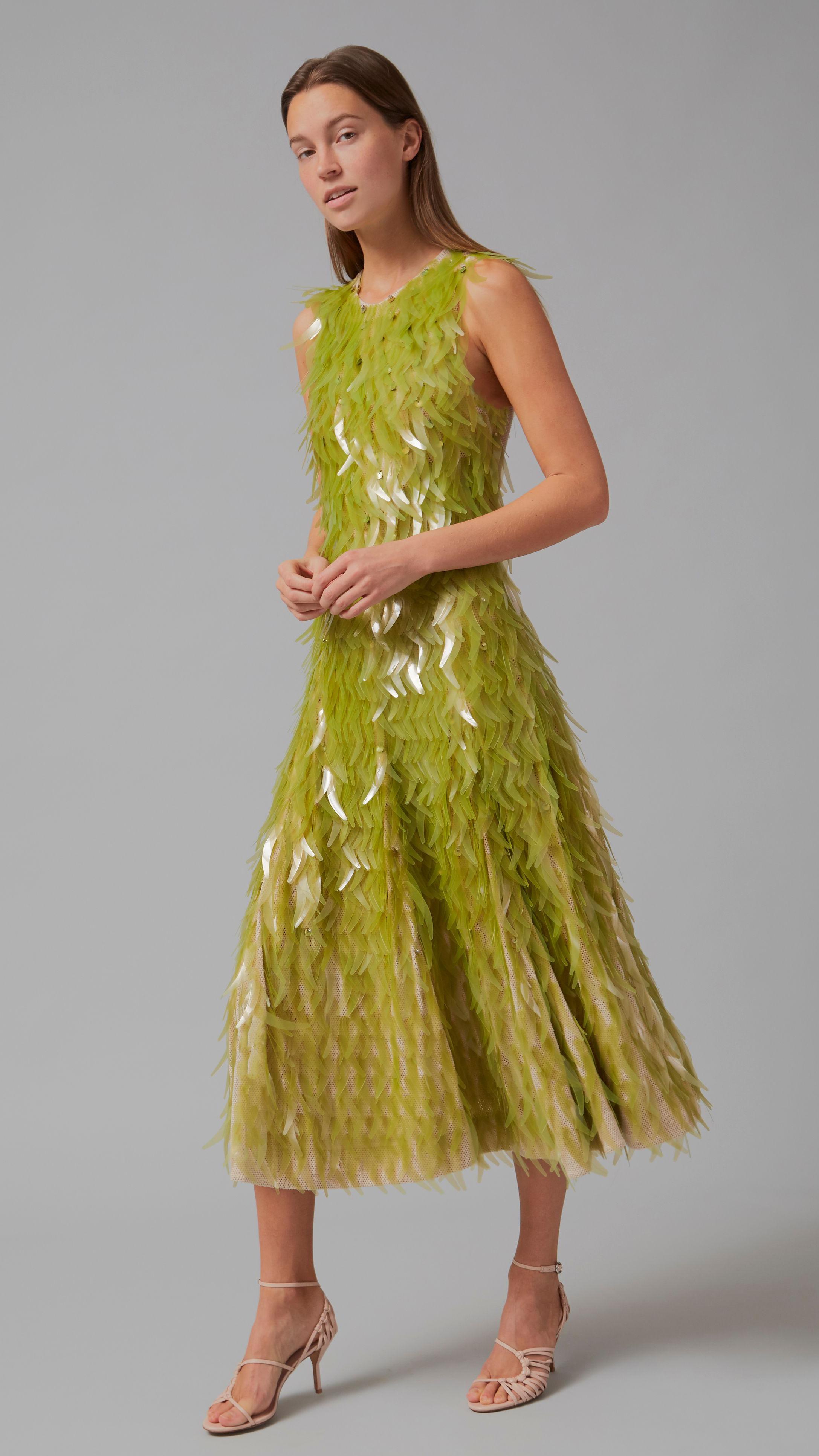 manekenka nosi haljinu srednje dužine, zelene boje, napravljene od algi 